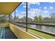 Balcony featuring screened enclosure with lake view and lush greenery at 13612 S Village Dr # 5201, Tampa, FL 33618