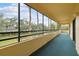 Large screened balcony overlooking lush landscaping, pond and mature trees at 13612 S Village Dr # 5201, Tampa, FL 33618