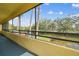 Screened-in balcony with pond view and mature trees at 13612 S Village Dr # 5201, Tampa, FL 33618