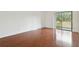 Sunlit bedroom featuring wood floors and a sliding door to the balcony at 13612 S Village Dr # 5201, Tampa, FL 33618