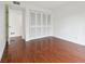 Empty bedroom features wood-look flooring and a large closet at 13612 S Village Dr # 5201, Tampa, FL 33618