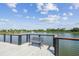 Scenic view from the dock with lake fountain, bench seating, and tranquil waterfront ambiance at 13612 S Village Dr # 5201, Tampa, FL 33618