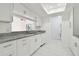 Kitchen with granite counters, white cabinets and a view to the living area at 13612 S Village Dr # 5201, Tampa, FL 33618