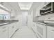The modern kitchen features white cabinets, stainless steel appliances, and granite countertops at 13612 S Village Dr # 5201, Tampa, FL 33618