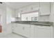 Kitchen featuring granite counters, white cabinets and stainless steel appliances at 13612 S Village Dr # 5201, Tampa, FL 33618