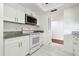 Bright, updated kitchen boasts white cabinetry, stainless steel appliances, and ample counter space at 13612 S Village Dr # 5201, Tampa, FL 33618