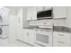 Laundry area featuring a stacked washer and dryer and all white cabinetry at 13612 S Village Dr # 5201, Tampa, FL 33618