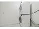Modern, stacked, white washer and dryer set appliances in laundry room area of home at 13612 S Village Dr # 5201, Tampa, FL 33618