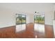 Bright living room with wood floors, ceiling fan, and sliding glass doors to screened lanai at 13612 S Village Dr # 5201, Tampa, FL 33618