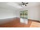 Spacious living room featuring wood floors and sliding glass doors to balcony at 13612 S Village Dr # 5201, Tampa, FL 33618