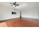 The cozy living room features hardwood floors and a ceiling fan for added comfort at 13612 S Village Dr # 5201, Tampa, FL 33618