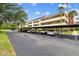 View of the covered parking area next to the condo building, offering shaded spots for residents and guests at 13612 S Village Dr # 5201, Tampa, FL 33618