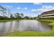 Picturesque pond with lush greenery and a partial view of the condo building at 13612 S Village Dr # 5201, Tampa, FL 33618
