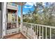 Balcony view showcasing wood floors, white railing, and neighborhood scenery at 1501 Doyle Carlton Dr # 303, Tampa, FL 33602