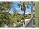 Charming balcony view features lush green trees, a waterway, and a clear blue sky with scattered clouds at 1501 Doyle Carlton Dr # 303, Tampa, FL 33602