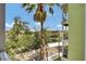 Attractive balcony view features a waterway, lush trees, and a clear blue sky with scattered clouds at 1501 Doyle Carlton Dr # 303, Tampa, FL 33602