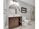 Bathroom boasts a contemporary vanity, stylish mirror, and toilet with tiled flooring and updated lighting at 1501 Doyle Carlton Dr # 303, Tampa, FL 33602