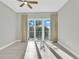 Bright bedroom with light hardwood floors and balcony access through glass doors at 1501 Doyle Carlton Dr # 303, Tampa, FL 33602