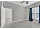 Bedroom featuring hardwood floors, blue curtains, and closet at 1501 Doyle Carlton Dr # 303, Tampa, FL 33602