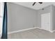 Neutral bedroom with ceiling fan, hardwood floors, and a closet door at 1501 Doyle Carlton Dr # 303, Tampa, FL 33602