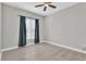 Cozy bedroom featuring a ceiling fan, a window with blinds and hardwood floors at 1501 Doyle Carlton Dr # 303, Tampa, FL 33602