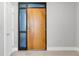 Modern front door with sleek design, side light windows, and neutral wall paint enhances the welcoming ambiance at 1501 Doyle Carlton Dr # 303, Tampa, FL 33602