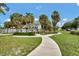 Scenic park view with palm trees, lush grass, and a winding sidewalk at 1501 Doyle Carlton Dr # 303, Tampa, FL 33602