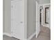 Hallway with multiple doors, wood floors, and neutral walls at 1501 Doyle Carlton Dr # 303, Tampa, FL 33602
