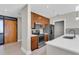 This kitchen features stainless appliances, wooden cabinets and a white quartz countertop at 1501 Doyle Carlton Dr # 303, Tampa, FL 33602
