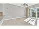 Living room with ceiling fan, wood floors and sliding glass doors to the balcony at 1501 Doyle Carlton Dr # 303, Tampa, FL 33602