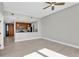 This living room has an open kitchen, a ceiling fan and wood floors at 1501 Doyle Carlton Dr # 303, Tampa, FL 33602