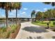 Charming Riverwalk scene features a paved path, lush grass, palm trees, and a scenic view of the bridge at 1501 Doyle Carlton Dr # 303, Tampa, FL 33602