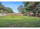 Well-kept, spacious backyard with a wooden fence, offering privacy and plenty of room for outdoor activities at 15820 Sapwood St, Tampa, FL 33624