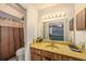 Bathroom with mirrored vanity and a view into the main bedroom at 15820 Sapwood St, Tampa, FL 33624