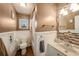Charming bathroom with wainscoting, decorative mirror, and coordinated fixtures offers a serene space at 15820 Sapwood St, Tampa, FL 33624