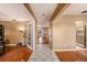 Inviting foyer with tile flooring leading into a spacious living area with hardwood floors at 15820 Sapwood St, Tampa, FL 33624