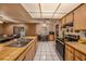Spacious kitchen with butcher block countertops, stainless steel appliances, and white tile flooring at 15820 Sapwood St, Tampa, FL 33624