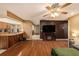 Spacious living room featuring hardwood floors and an open floor plan leading to kitchen at 15820 Sapwood St, Tampa, FL 33624