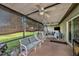Spacious screened-in porch with comfortable seating, ideal for outdoor relaxation and entertainment at 15820 Sapwood St, Tampa, FL 33624