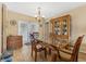 Dining room with a glass table, wooden chairs, and a charming display cabinet at 15917 Crying Wind Dr, Tampa, FL 33624