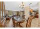 Open-concept dining area with a glass table, seamlessly connecting to the living room at 15917 Crying Wind Dr, Tampa, FL 33624
