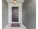Inviting front entrance with a dark-colored door and textured walls at 15917 Crying Wind Dr, Tampa, FL 33624
