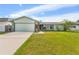 Charming single-story home featuring a well-manicured lawn and attached garage at 15917 Crying Wind Dr, Tampa, FL 33624