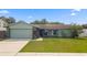 Charming single-story home with a well-maintained front lawn and attached garage at 15917 Crying Wind Dr, Tampa, FL 33624