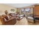 Cozy living room with comfortable leather furniture, neutral walls and tiled floor at 15917 Crying Wind Dr, Tampa, FL 33624