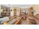 Open concept living room with leather furniture, tiled floor and dining area at 15917 Crying Wind Dr, Tampa, FL 33624