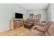 Comfortable living room with tiled flooring, a large TV, and plush seating for relaxation at 15917 Crying Wind Dr, Tampa, FL 33624