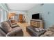 Open-concept living room featuring tiled floors and a seamless transition to the kitchen and dining area at 15917 Crying Wind Dr, Tampa, FL 33624