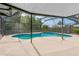 Sparkling private pool in a screened enclosure with a concrete patio at 15917 Crying Wind Dr, Tampa, FL 33624