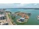 Aerial view of a stunning waterfront community with boat docks and breathtaking bay views at 1651 Sand Key Estates Ct # 54, Clearwater Beach, FL 33767